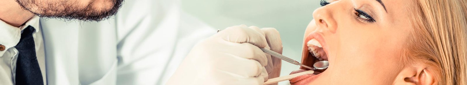 Dentist examining patient teeth before tooth extractions