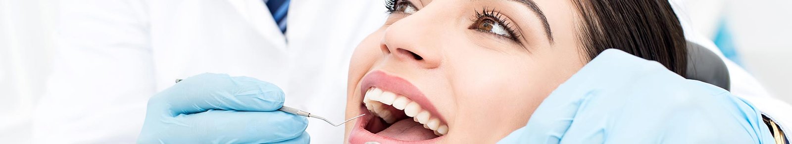 Dentist examining patient teeth