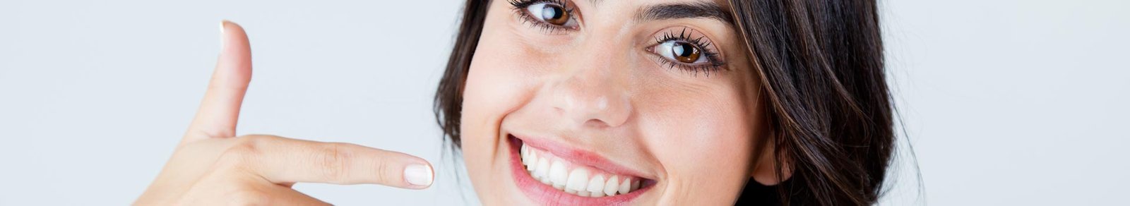 Woman pointing at her teeth